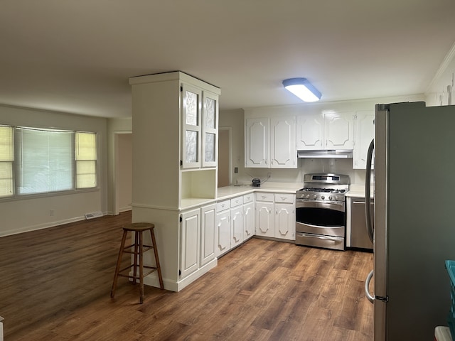 kitchen with white cabinets, dark hardwood / wood-style flooring, and stainless steel appliances