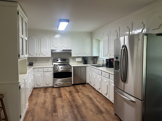 kitchen featuring dark hardwood / wood-style floors, white cabinetry, sink, and appliances with stainless steel finishes