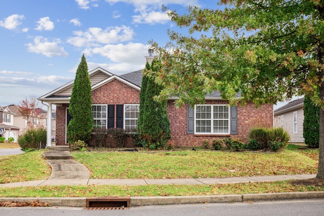 obstructed view of property featuring a front lawn