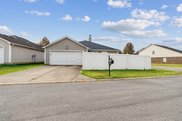 view of front of property with a garage and a front lawn