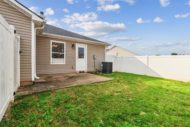 rear view of property featuring a lawn, cooling unit, and a patio