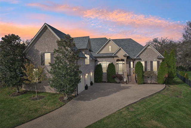 view of front facade featuring a lawn and a garage