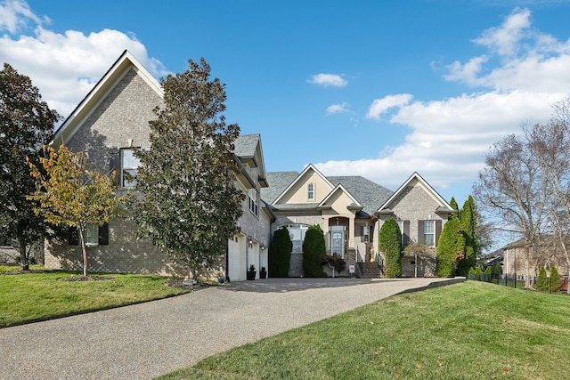 view of front of home with a garage and a front lawn