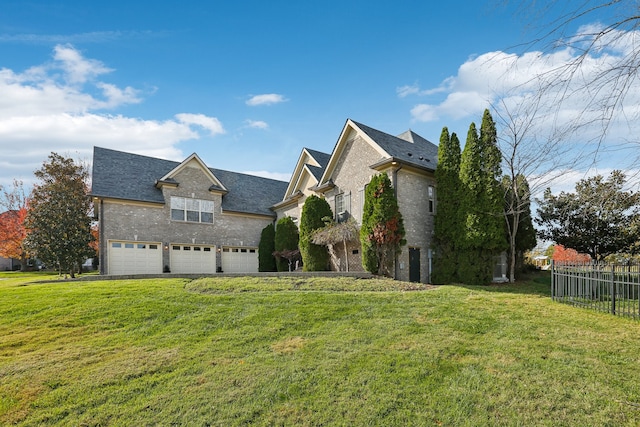 view of side of property featuring a yard and a garage