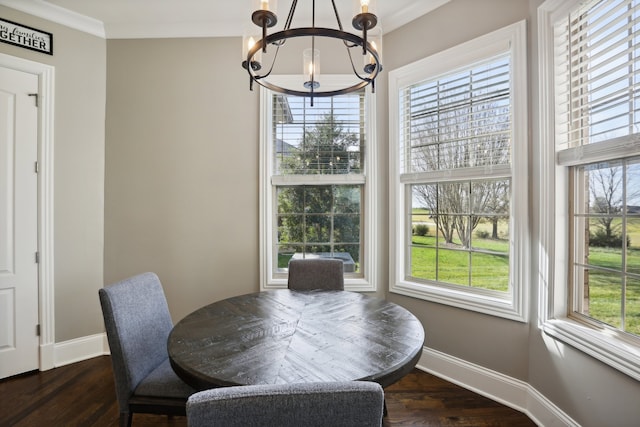 dining area with a chandelier, dark wood-type flooring, and a healthy amount of sunlight