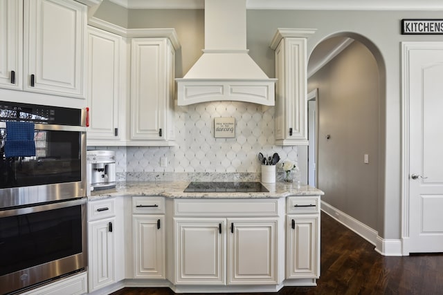 kitchen with custom exhaust hood, dark hardwood / wood-style flooring, white cabinetry, and black electric cooktop