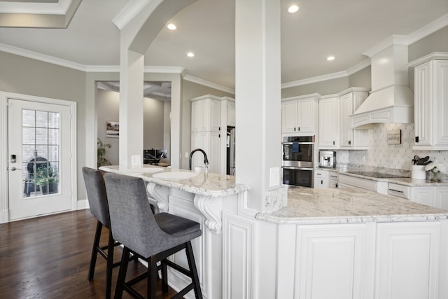 kitchen with white cabinetry, dark hardwood / wood-style flooring, and stainless steel double oven