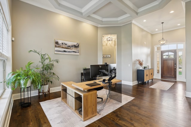 office space with an inviting chandelier, dark hardwood / wood-style flooring, a high ceiling, and coffered ceiling