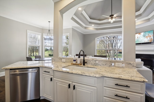 kitchen with dishwasher, sink, decorative light fixtures, white cabinets, and ornamental molding