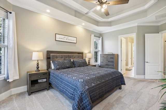 bedroom with ceiling fan, crown molding, light carpet, and connected bathroom