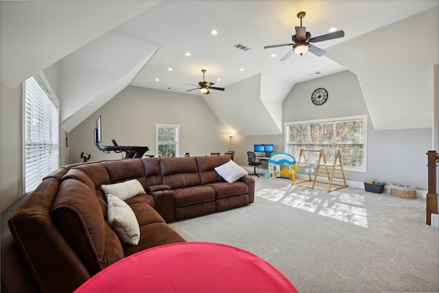 carpeted living room with ceiling fan and lofted ceiling