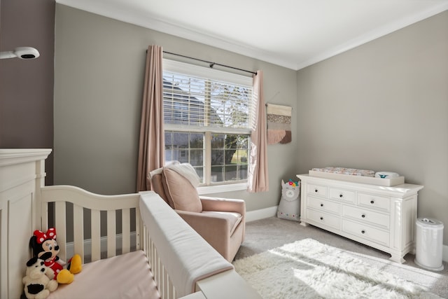 carpeted bedroom featuring a crib and crown molding