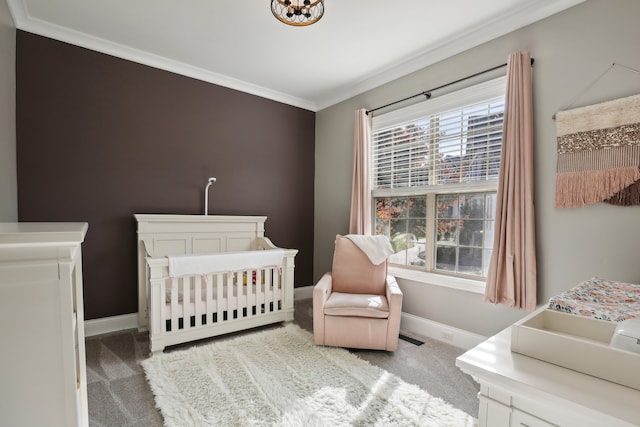 bedroom with ornamental molding, a crib, carpet floors, and multiple windows