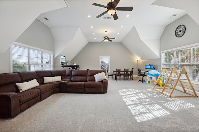 living room with light colored carpet, a wealth of natural light, and ceiling fan