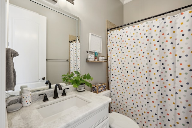 bathroom with vanity, toilet, and walk in shower