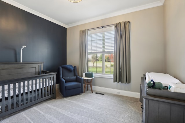 bedroom with light carpet, crown molding, and a nursery area