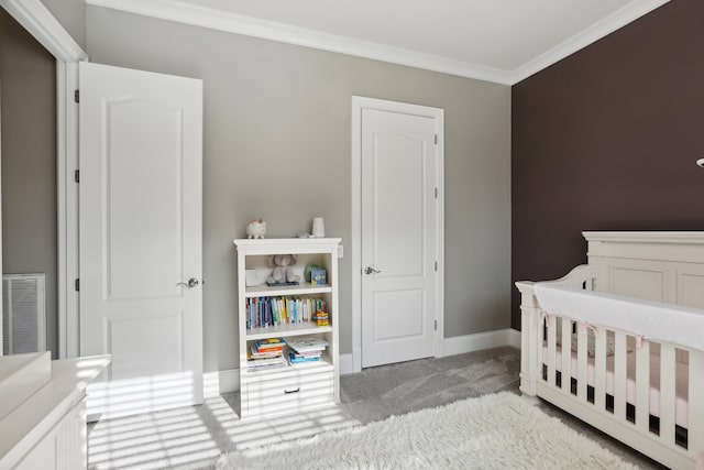 bedroom featuring light colored carpet, ornamental molding, and a nursery area