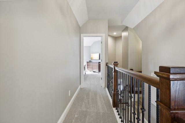 hall featuring light carpet and lofted ceiling