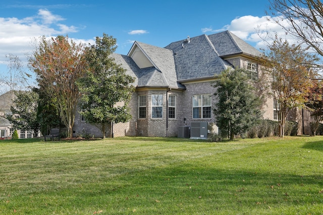 exterior space with a lawn and central AC