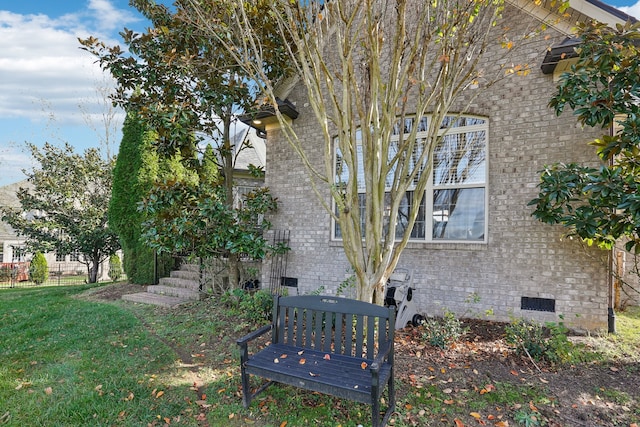 view of side of home with a yard