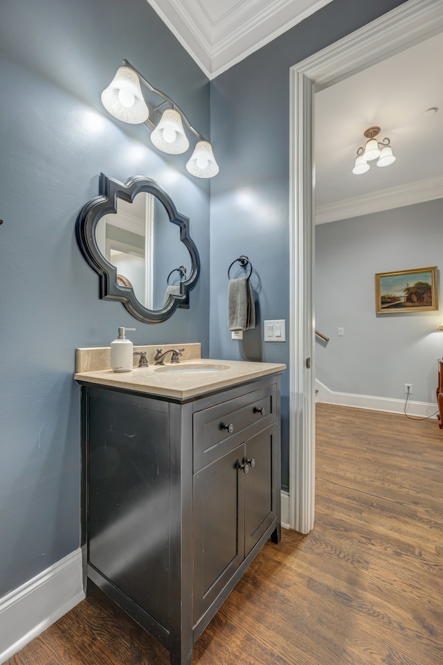 bathroom featuring hardwood / wood-style floors, vanity, and ornamental molding