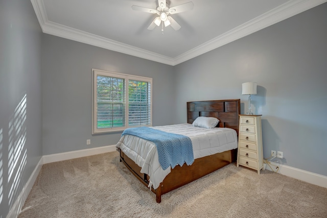 carpeted bedroom featuring ceiling fan and ornamental molding