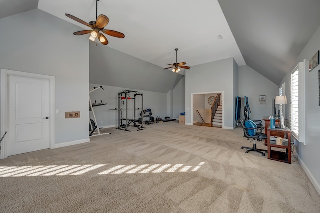 workout area featuring ceiling fan, light colored carpet, and vaulted ceiling