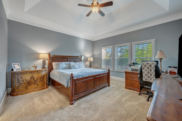 bedroom with a tray ceiling, ceiling fan, and light carpet