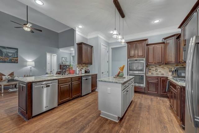 kitchen with a center island, pendant lighting, dark hardwood / wood-style floors, and appliances with stainless steel finishes