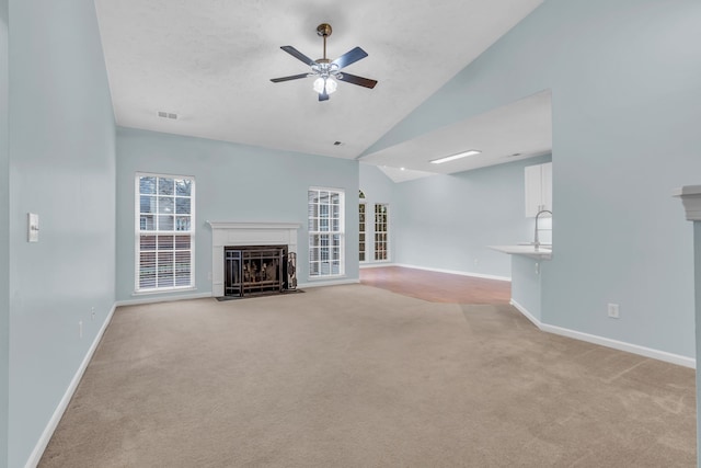 unfurnished living room with light colored carpet and vaulted ceiling