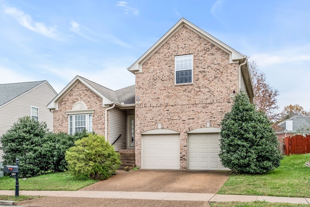 view of front property featuring a front yard and a garage