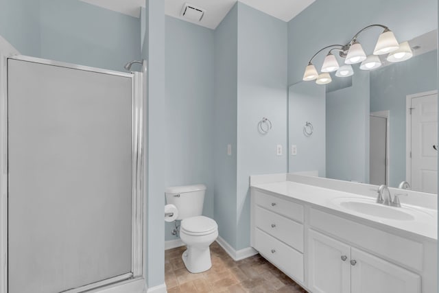 bathroom with vanity, a shower with shower door, and toilet