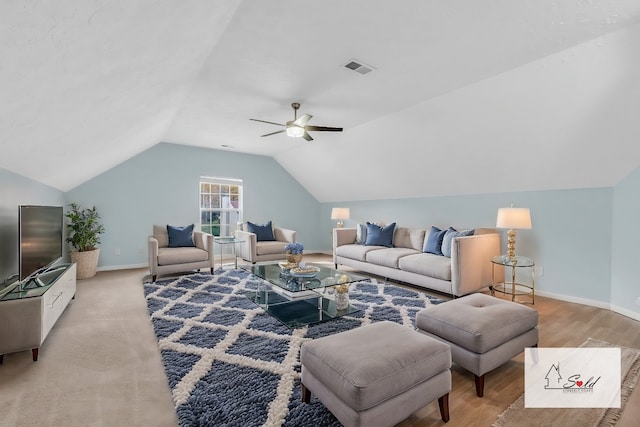 living room featuring ceiling fan, light hardwood / wood-style flooring, and lofted ceiling