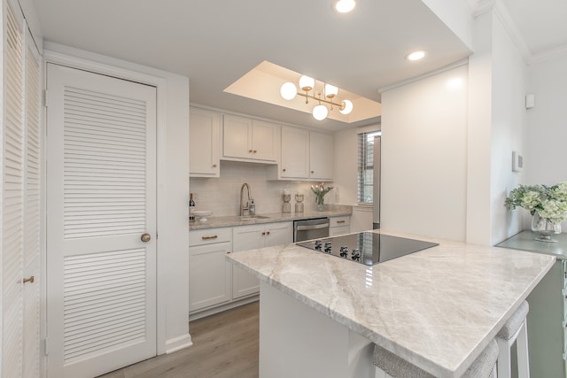 kitchen featuring light wood-type flooring, tasteful backsplash, ornamental molding, black electric cooktop, and white cabinets