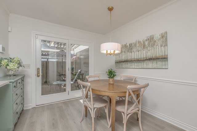 dining space featuring light hardwood / wood-style floors and ornamental molding