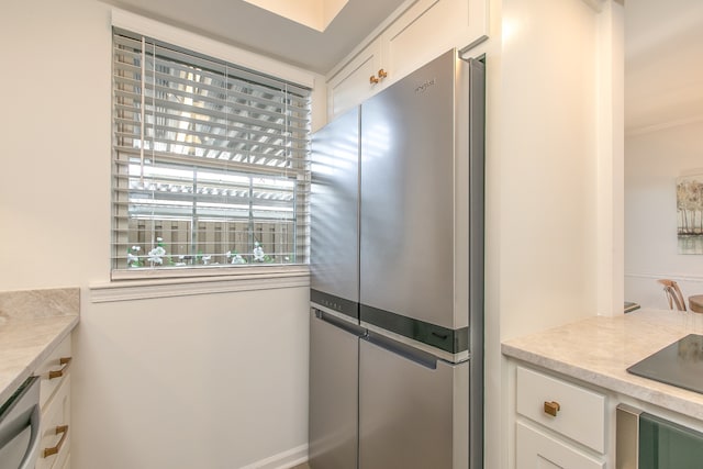 kitchen featuring stainless steel appliances and white cabinetry