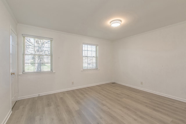 spare room featuring light hardwood / wood-style floors and crown molding