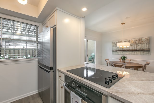 kitchen featuring light stone countertops, appliances with stainless steel finishes, dark hardwood / wood-style flooring, pendant lighting, and white cabinetry