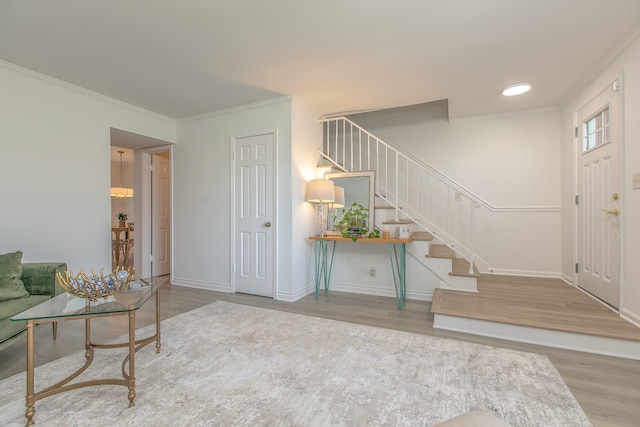 foyer entrance featuring hardwood / wood-style flooring and ornamental molding