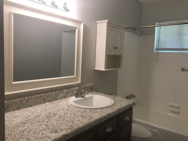 full bathroom featuring vanity, toilet, and tiled shower / bath combo