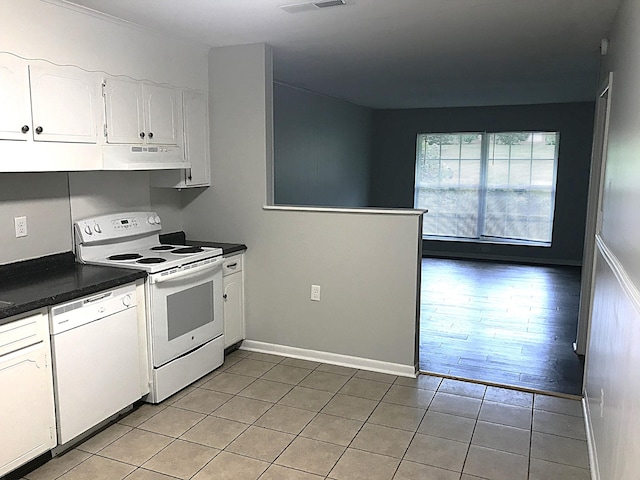 kitchen with white cabinetry, light hardwood / wood-style floors, and white appliances