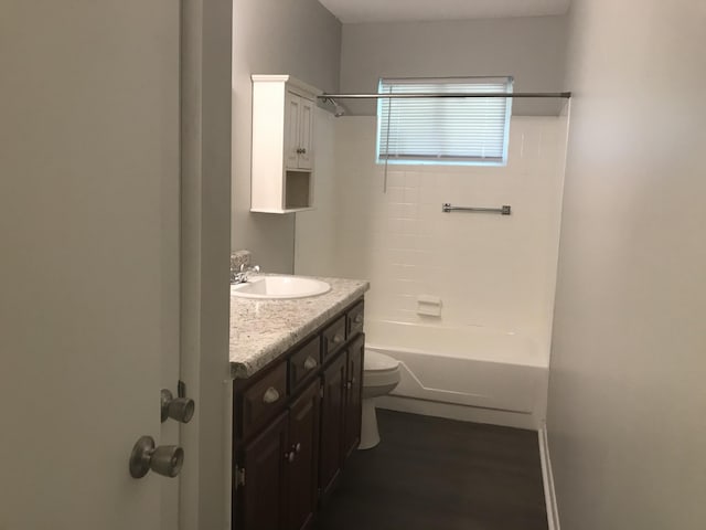 full bathroom featuring wood-type flooring, vanity, toilet, and shower / washtub combination