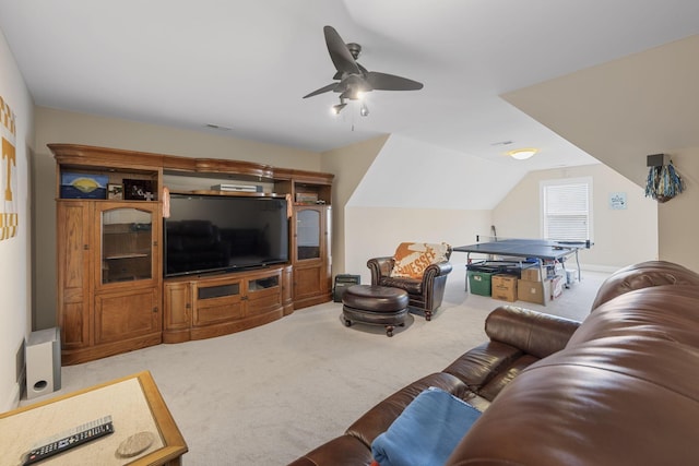 carpeted living room featuring ceiling fan and lofted ceiling