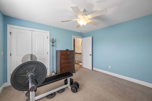 workout room featuring ceiling fan and carpet floors