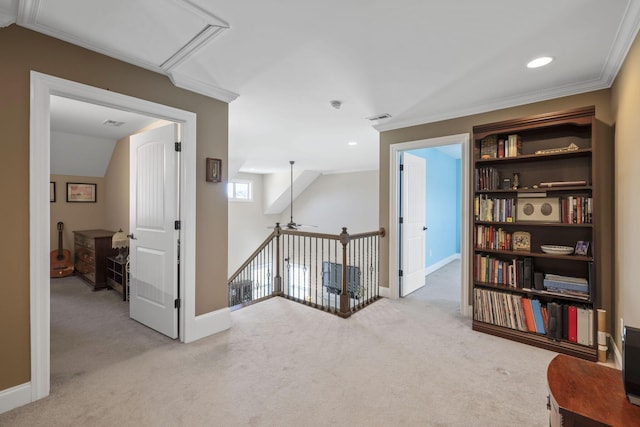 hallway featuring light carpet, lofted ceiling, and ornamental molding