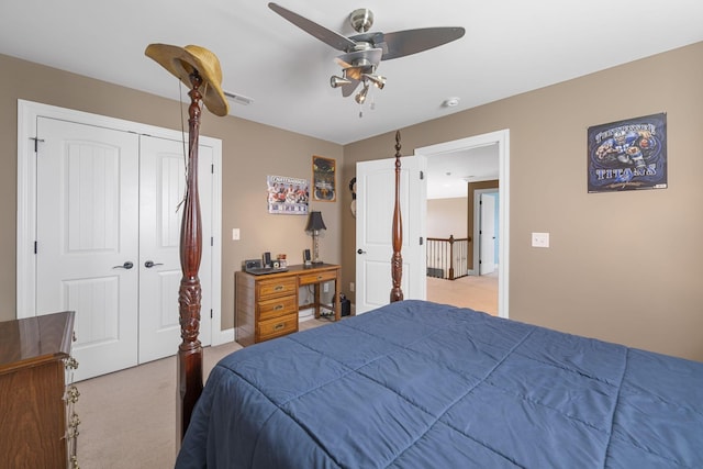 carpeted bedroom featuring ceiling fan and a closet