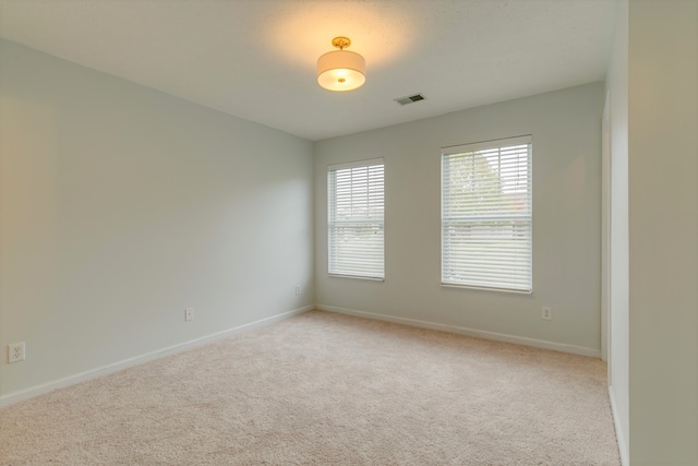 empty room featuring light colored carpet