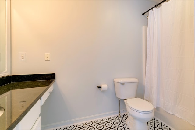 full bathroom with tile patterned floors, shower / bathtub combination with curtain, vanity, and toilet