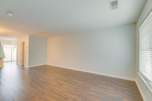 3425 Harpeth Springs Dr, Nashville, TN 37221 - empty room with dark wood-style floors, plenty of natural light, baseboards, and a textured ceiling
