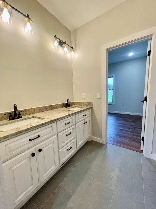 bathroom with vanity and hardwood / wood-style flooring